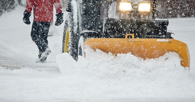 pedestrian walking on snow covered road