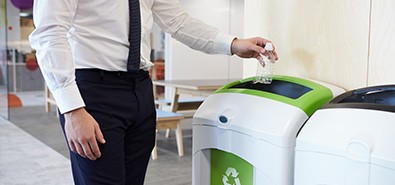 office worker recycling plastic bottle