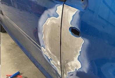 car door panel being repaired