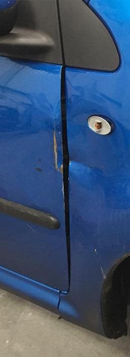 Repairing Car Scratches - dent damage on a blue car door