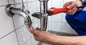 plumber repairing a leaking sink
