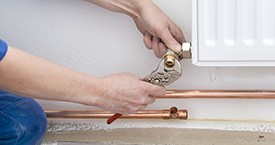 engineer fixing radiator piping