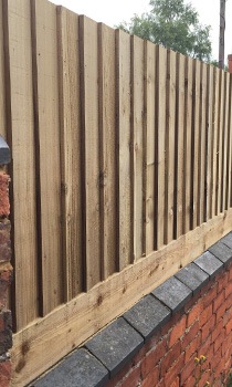 wooden fence on top of wall