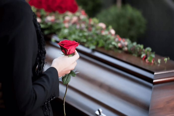 Holding a rose - Organising A Funeral