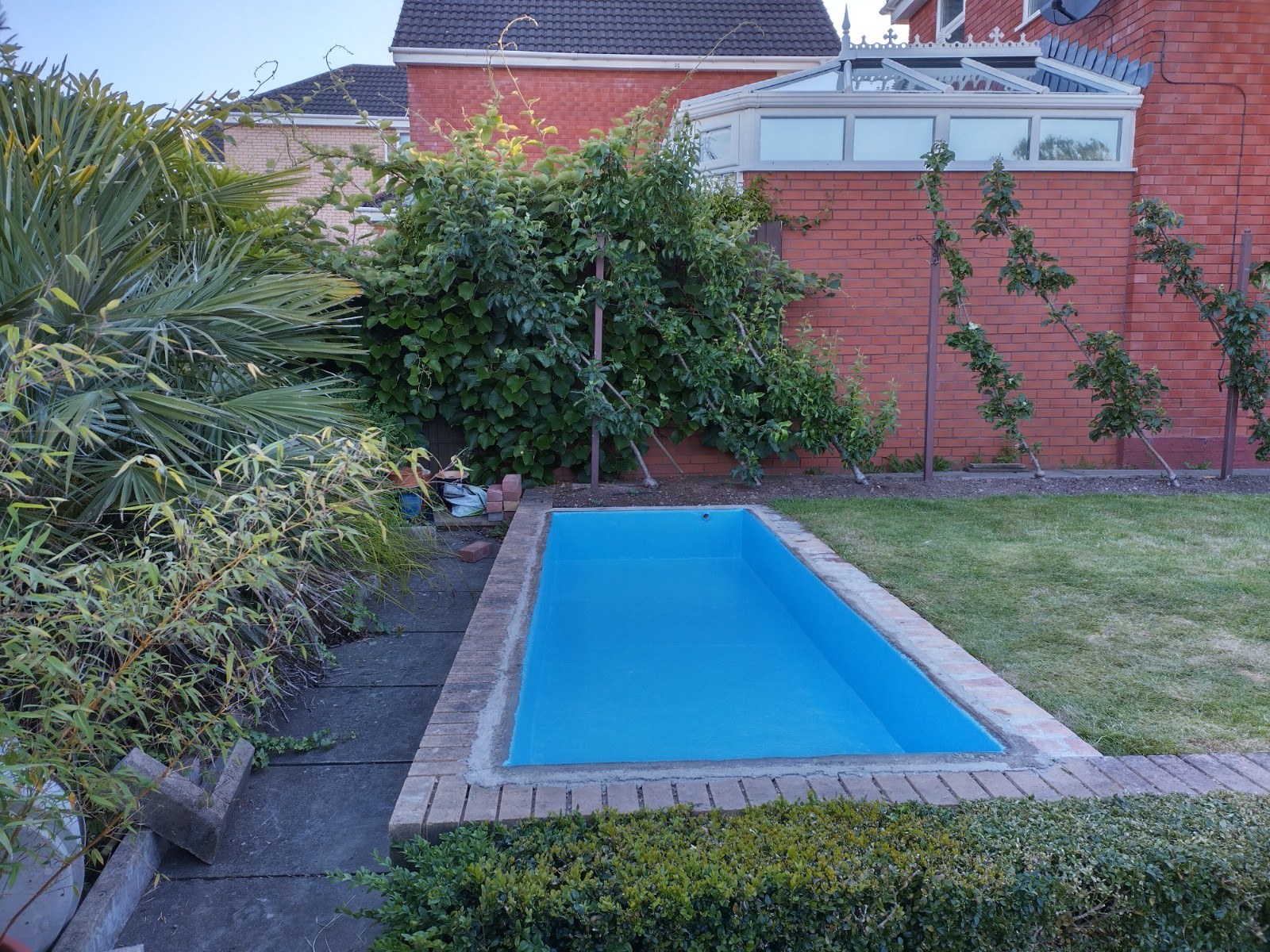 Fibreglass feature pond in Newport with blue flocoat.
