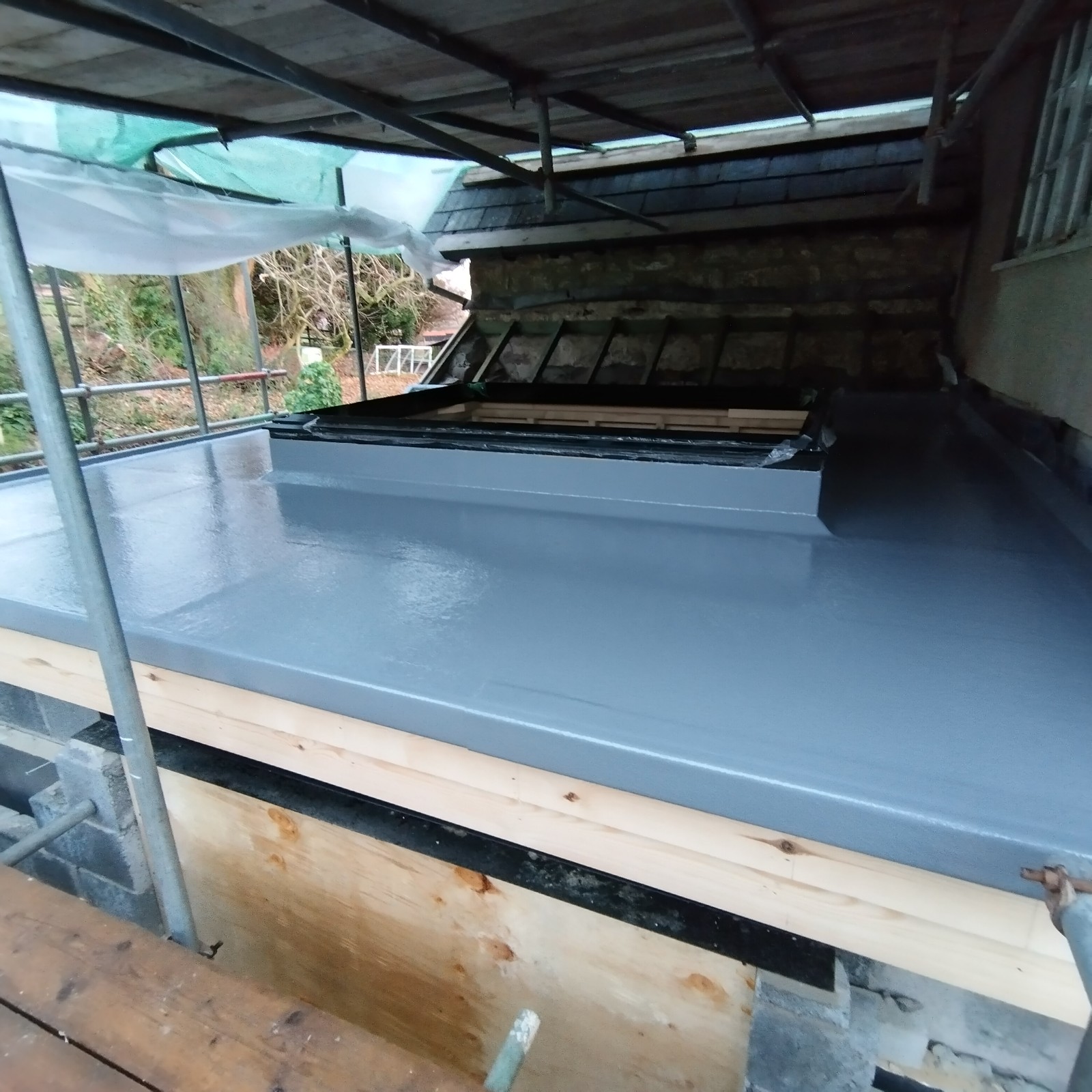 Flat roof in Chepstow with skylight under low scaffold.