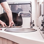 inspecting the plumbing on a motorhome