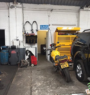 view of the workshop with vehicles being serviced