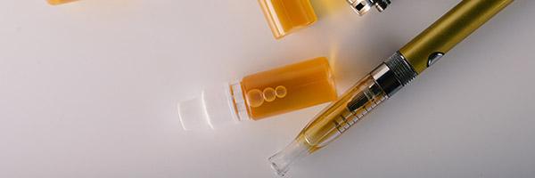bottles of e-liquid and an e-cigarette