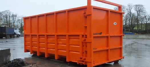 photo of red industrial roll on roll off skip