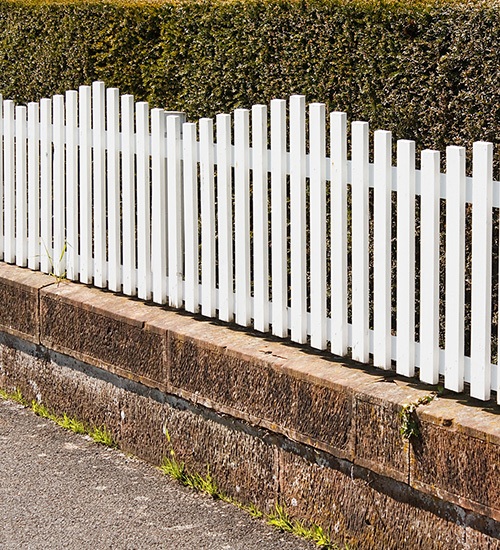 white picket fence on short wall