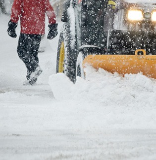 snowplough clearing a pedestrian road