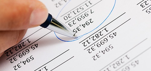 How can we help you with your accounts? close up view of accountant circling numbers