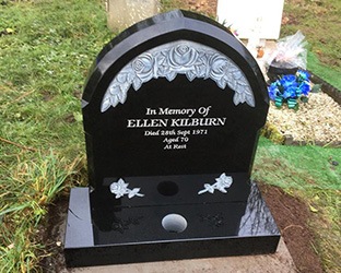 granite headstone with carved roses