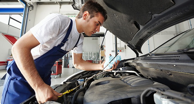 mechanic inspecting under the bonnet