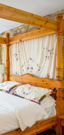 wooden four poster bed