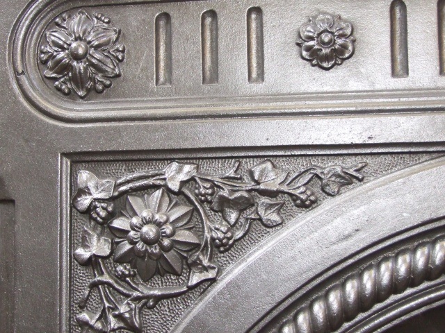 close up detail of cast iron antique fireplace surround