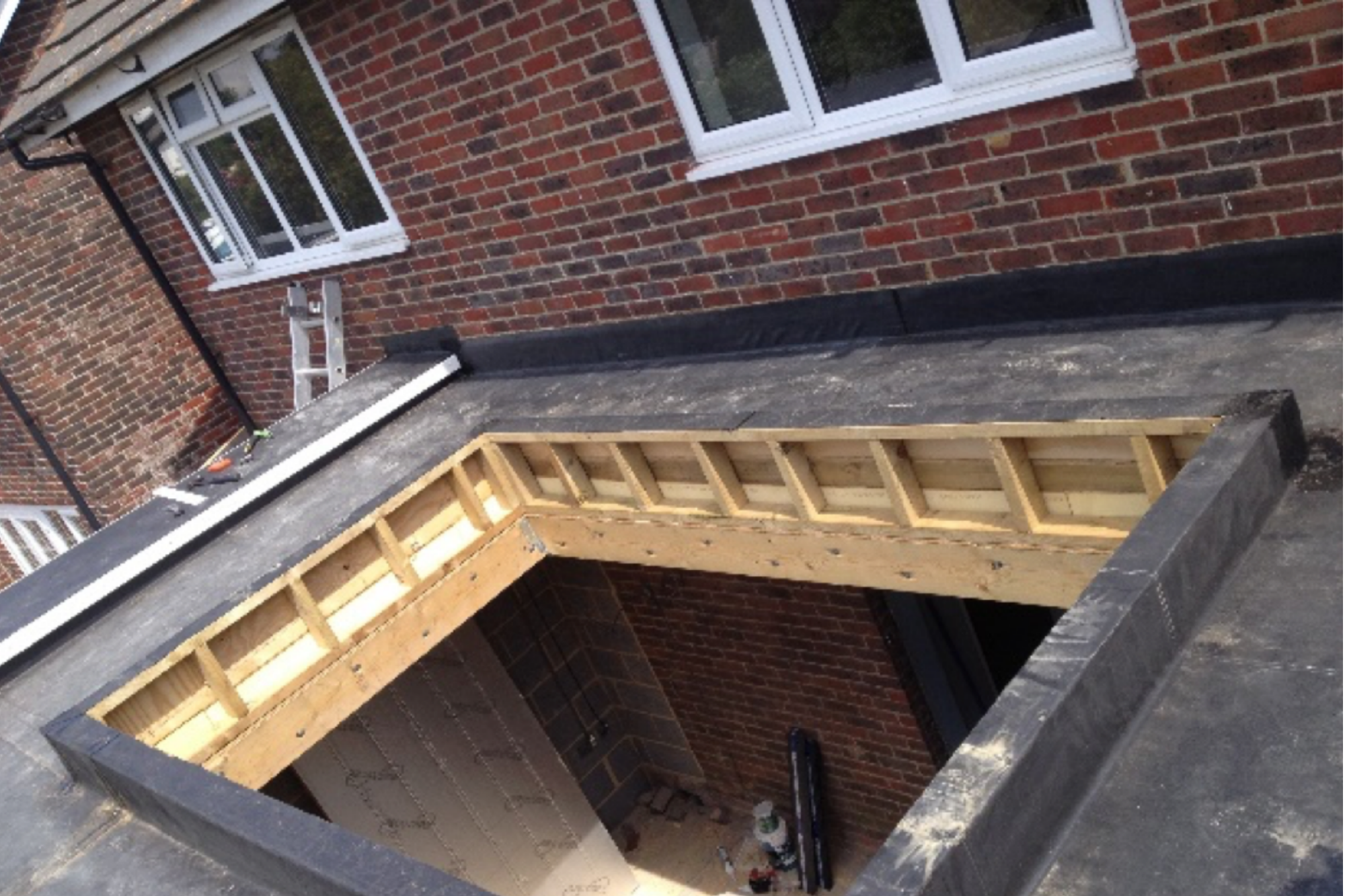 Flat roof rebuilt with a new timber frame around a rooflight opening