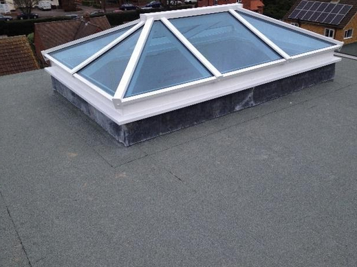 White framed roof lantern on a grey flat roof