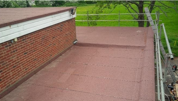Red mineral felt flat roof on a village hall