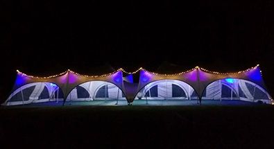 trapeze marquee light up at night