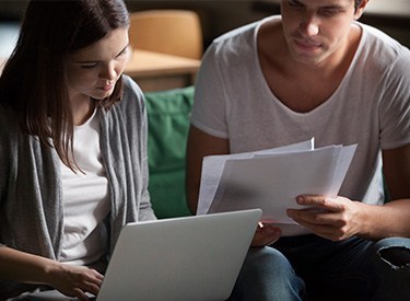 young couple discussing over documents