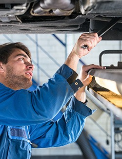 mechanic examining suspension