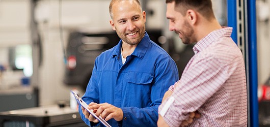 mechanic explaining mot report to customer