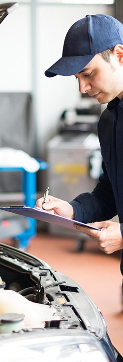 mechanic with servicing checklist
