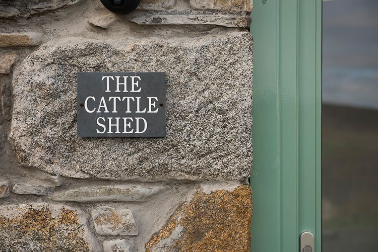 slate sign on side of cottage