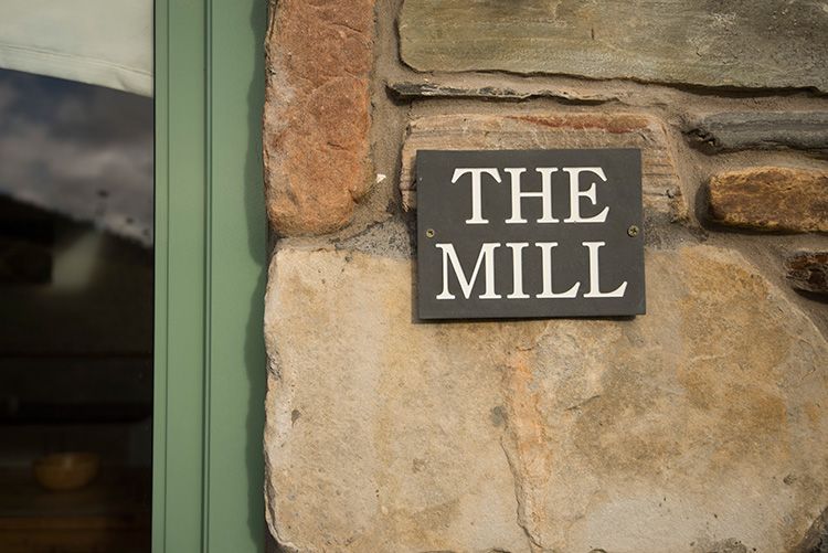 slate sign outside the cottage