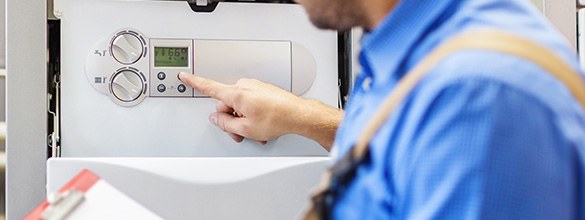 heating engineer inspecting boiler