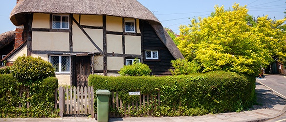 traditional English cottage with hedge in front garden