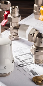 plumbing components laid out over plan drawings